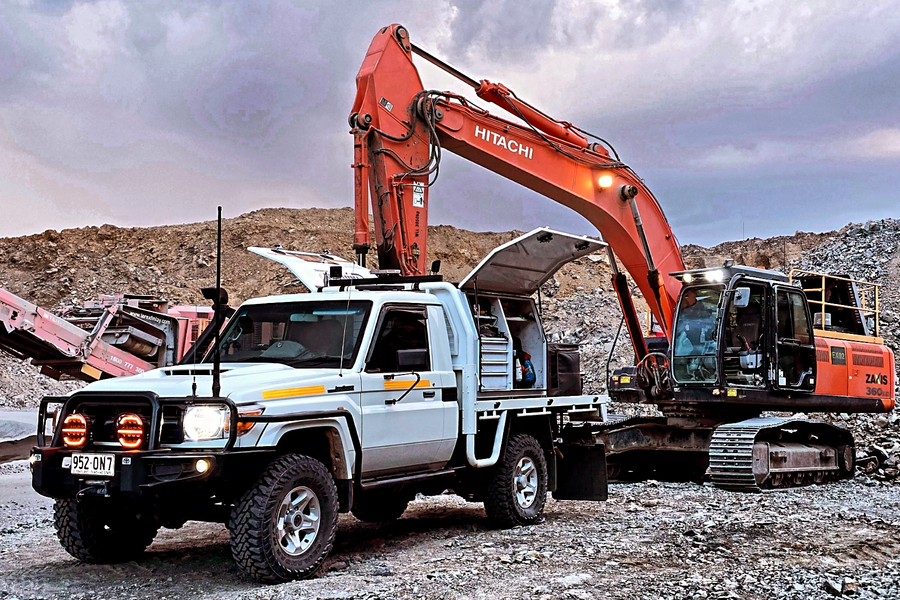 Mobile diesel mechanic repairing truck engine on-site